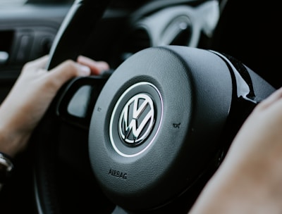Person holding steering wheel